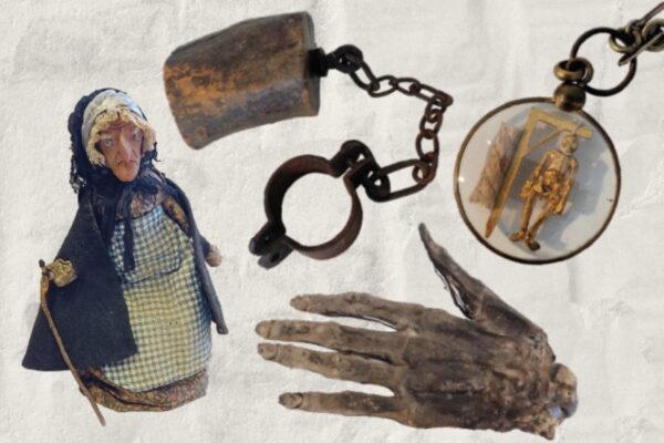 Poster with title 'Curiouser and Curiouser' in swirly font with 'an exhibition of the creepy, captivating, magical and mysterious at Whitby Museum' below. Underneath are colourful images of an old woman doll, a block of wood on a chain, a severed mumified hand, and a pendant of a hanging man on a gibbett.